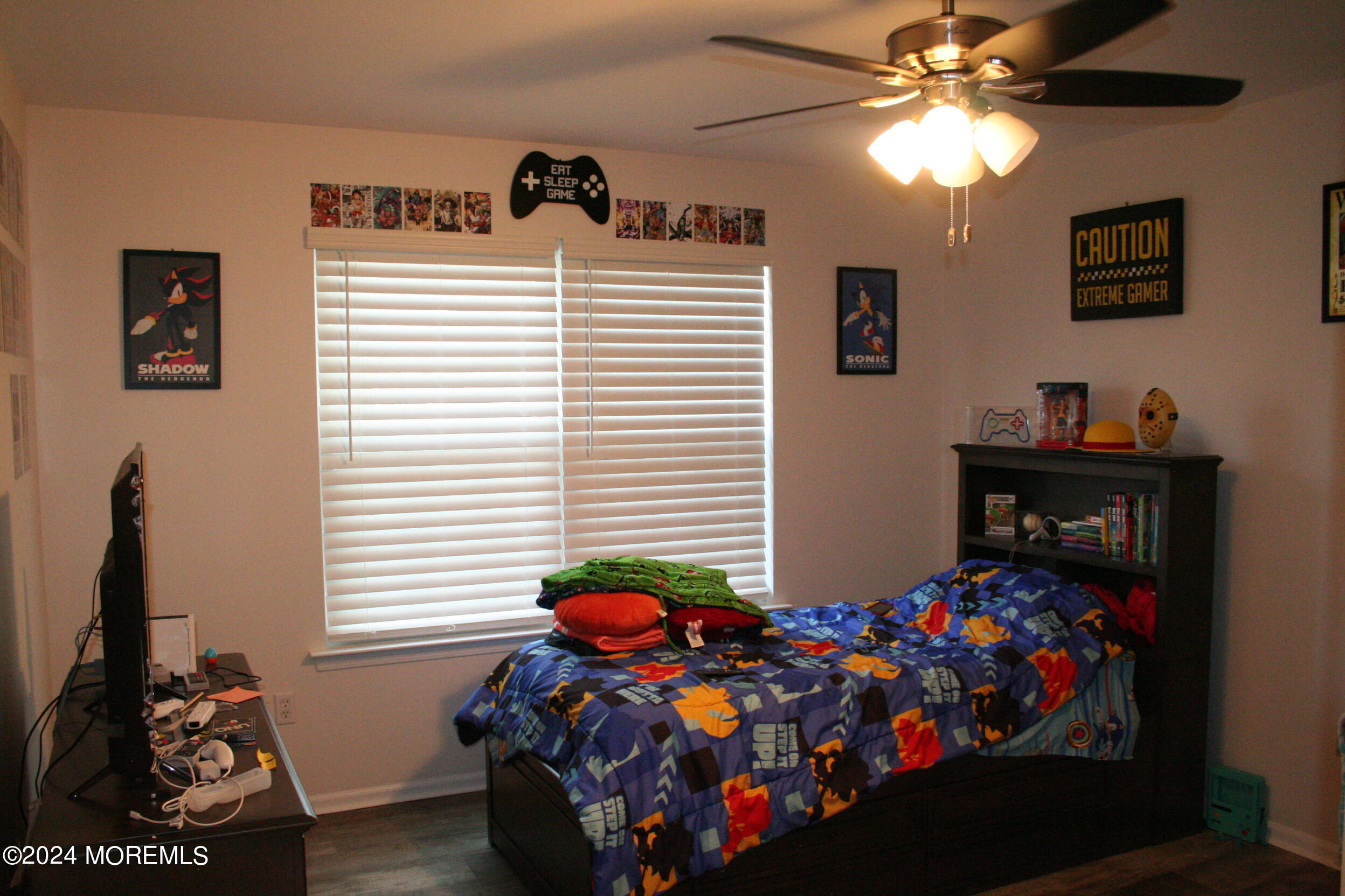 307 Lighthouse Drive Manahawkin, NJ 08050 - Photo 34 of 47 a bedroom with a bed and a chandelier