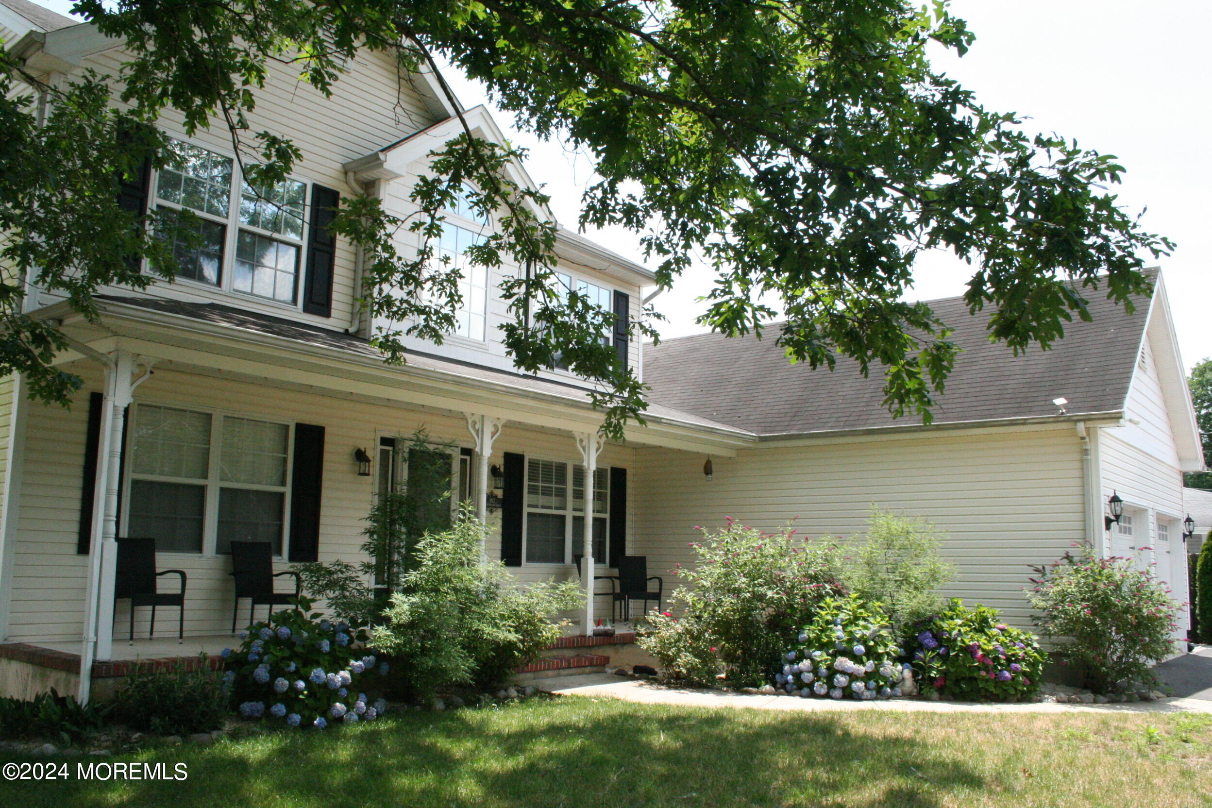 307 Lighthouse Drive Manahawkin, NJ 08050 - Photo 4 of 47 front view of a house with a garden