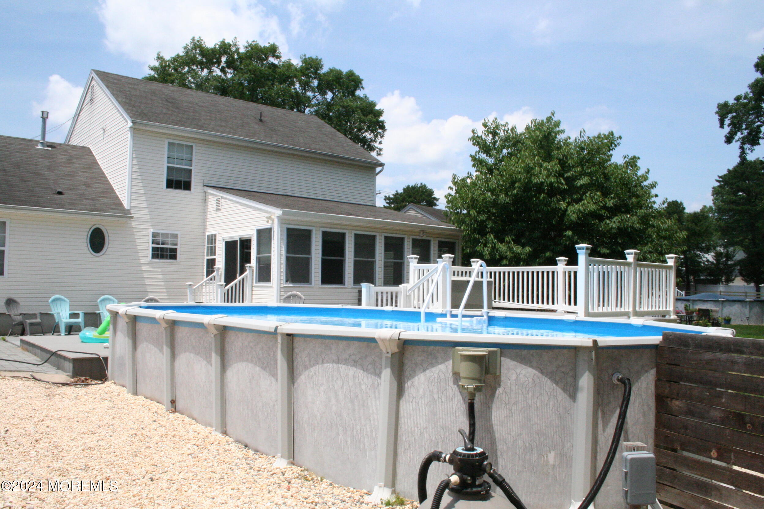 307 Lighthouse Drive Manahawkin, NJ 08050 - Photo 7 of 47 a view of a house with a swimming pool