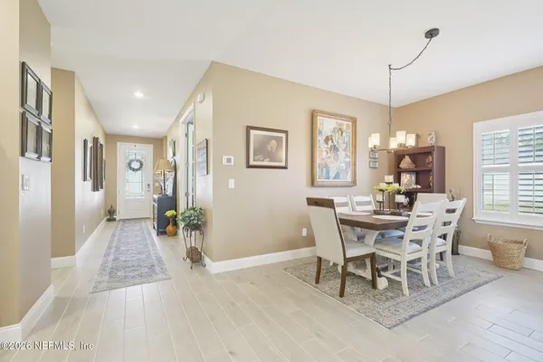 a dining room with wooden floor and breakfast area