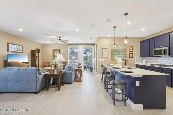 a large kitchen with a table and chairs