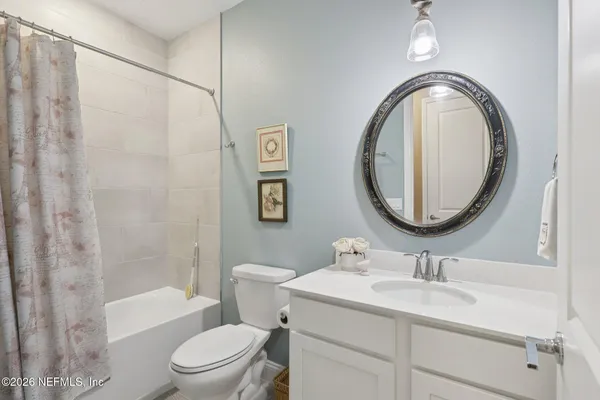a bathroom with a toilet a sink and a mirror