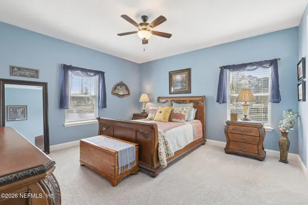 a bedroom with a bed couch and window