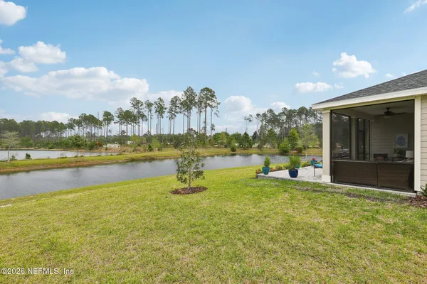 a view of house with backyard and porch