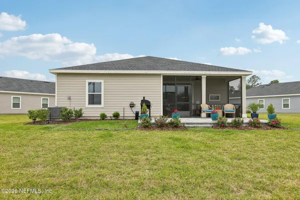 a view of a house with a backyard