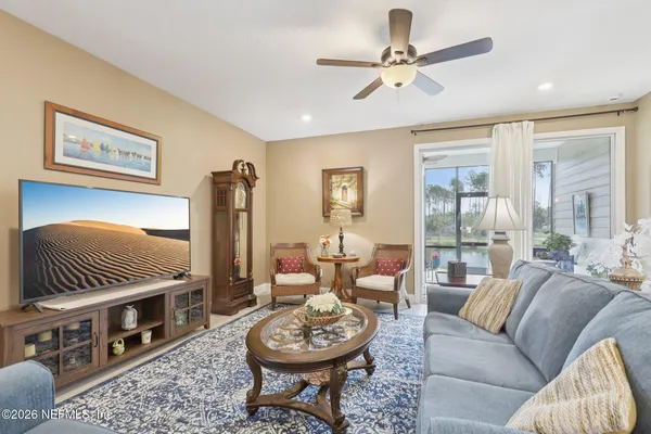 a living room with furniture a rug and a chandelier