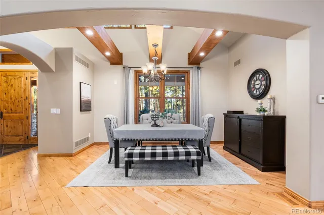 a living room with a table and a clock on the wall