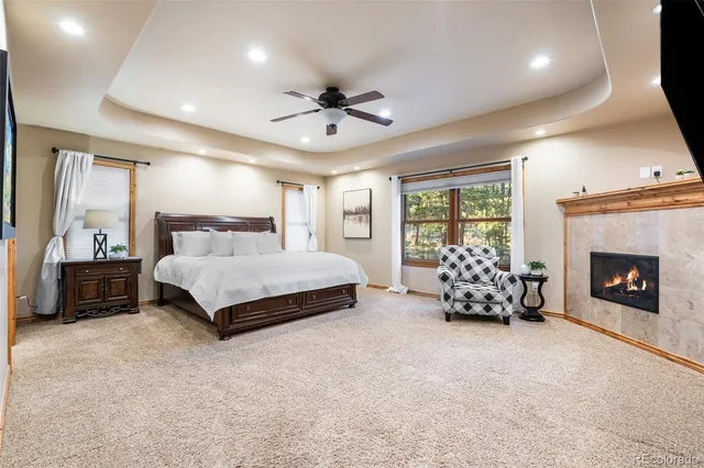 a spacious bedroom with a bed and a fireplace