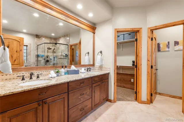 a bathroom with a granite countertop sink mirror and double
