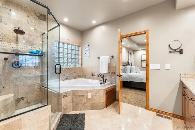 a spacious bathroom with a tub sink and shower