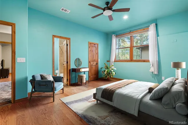 a bedroom with a bed couch and a window