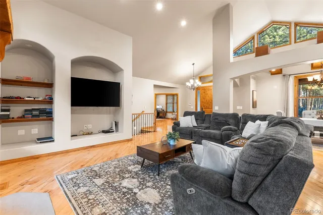 a living room with fireplace furniture and a flat screen tv
