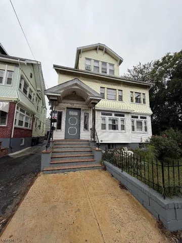 a front view of a house with a large window