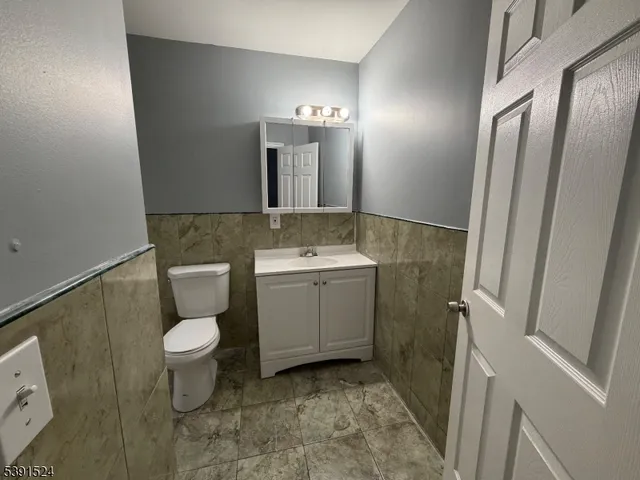 a bathroom with a sink toilet and mirror