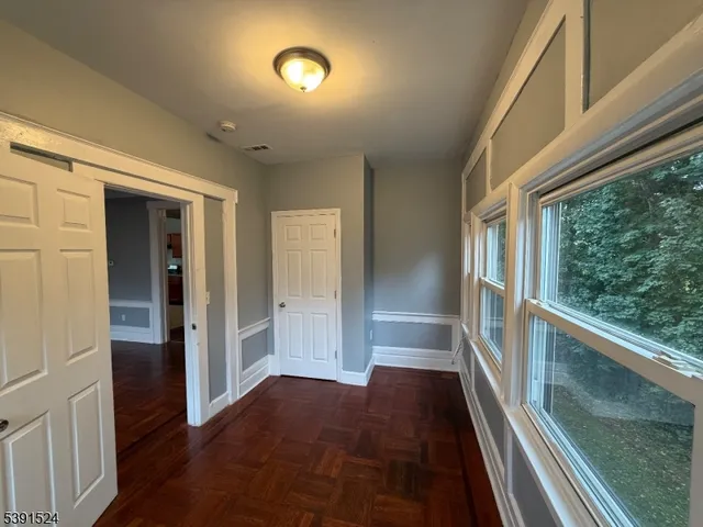 a view of gallery with wooden floor