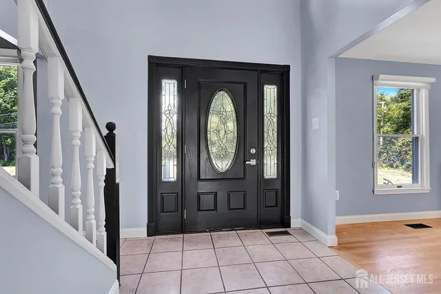 a view of entryway with wooden floor and window