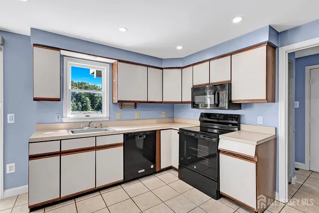 a kitchen with appliances cabinets and a sink