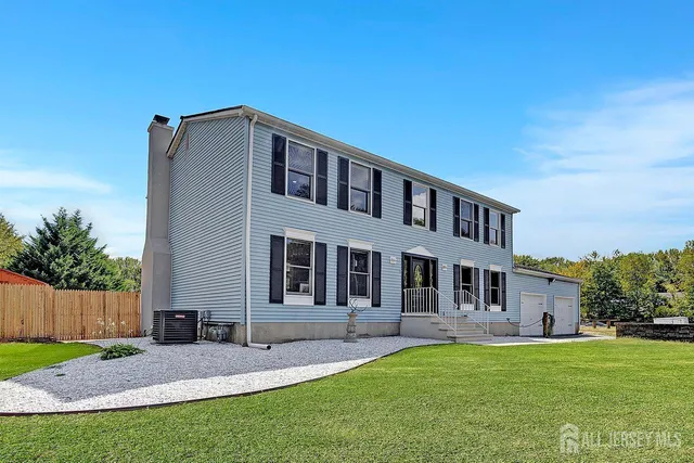 a backyard of a house with table and chairs