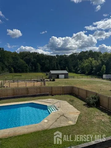 a view of a swimming pool with a yard