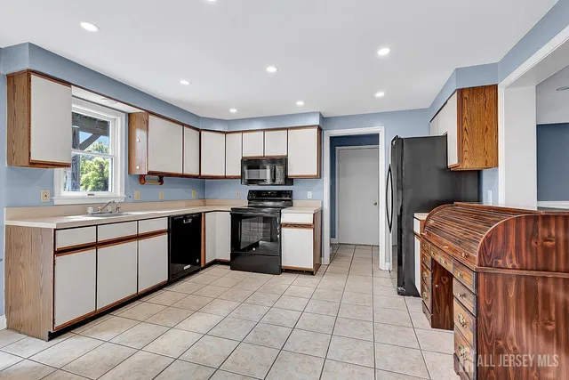 a kitchen with a sink a counter top space and stainless steel appliances