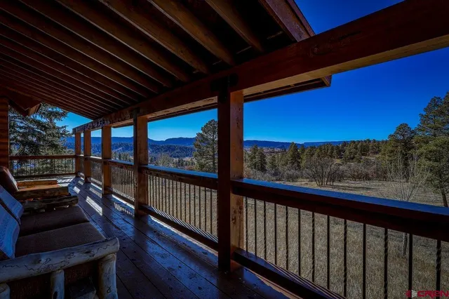 a living room with stainless steel appliances kitchen island granite countertop furniture and a rug
