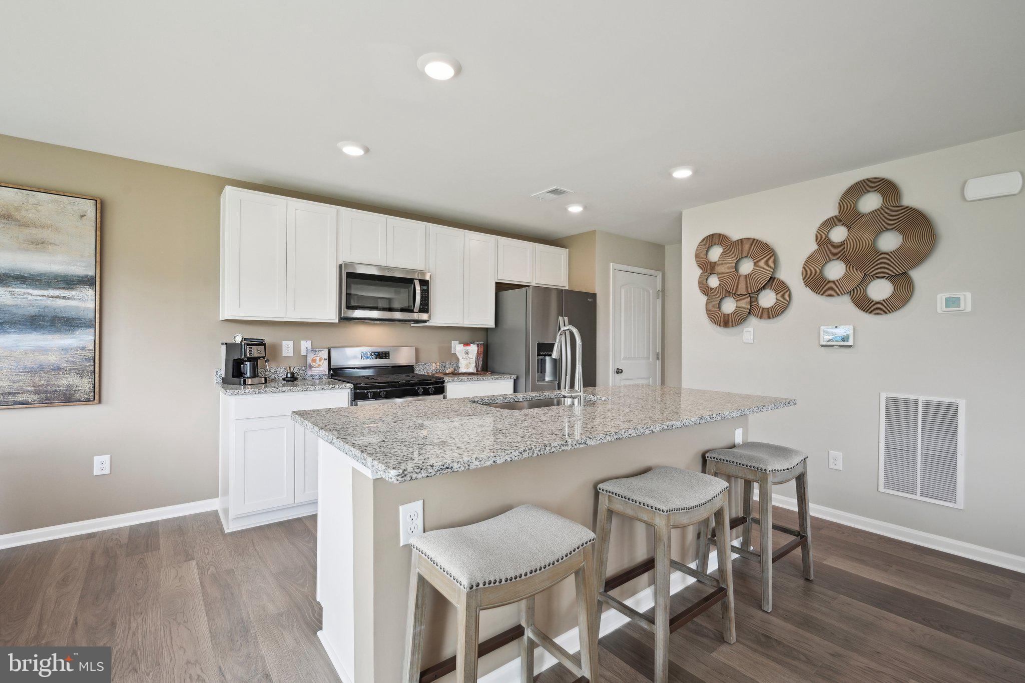 1158 Wintermead Loop Salisbury, MD 21801 - Photo 12 of 40 a large kitchen with a table and chairs in it