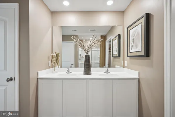 a bathroom with a double vanity sink and a mirror