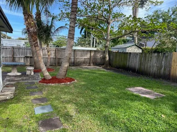 a view of a chair and table in backyard