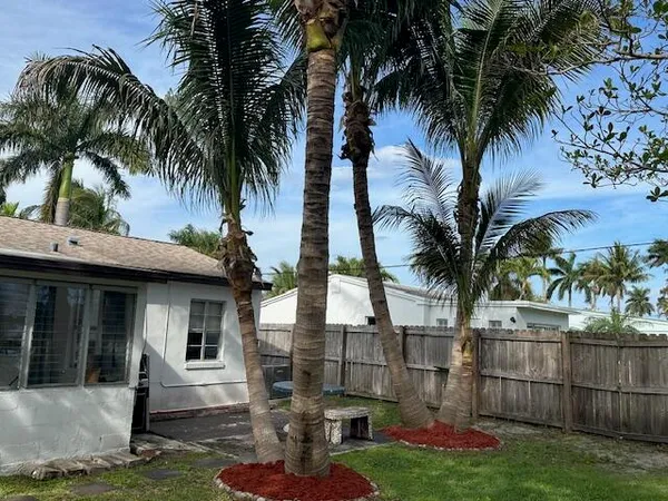 a backyard of a house with table and chairs