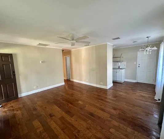 a kitchen with stainless steel appliances granite countertop a sink cabinets and wooden floor