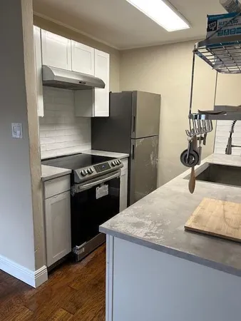 a kitchen with a stove and a refrigerator