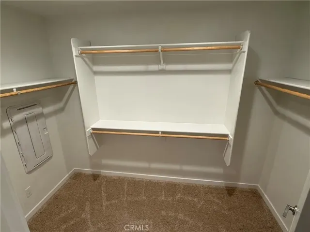 an empty room with closet and mirror