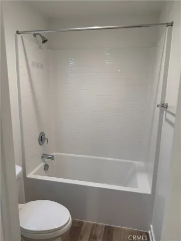 a white toilet sitting next to a bathroom sink