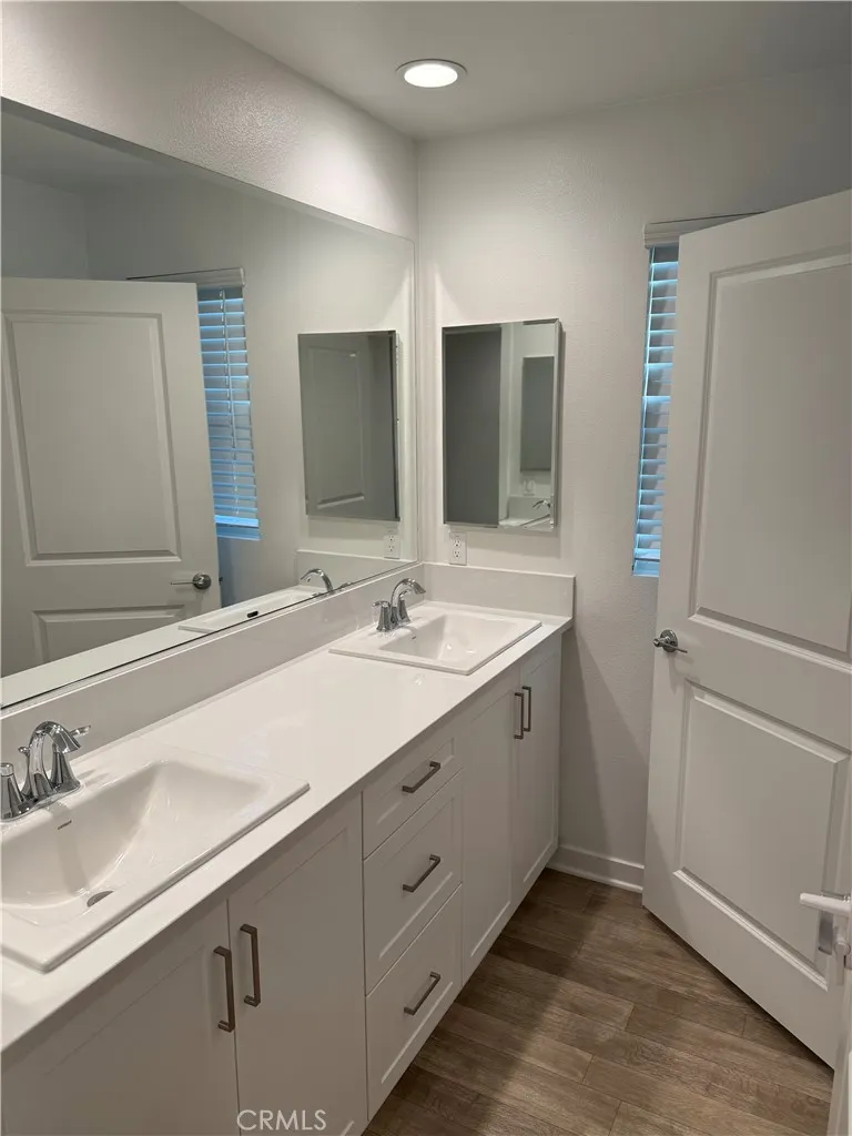 9504 North Corterra Panorama City, CA 91402 - Photo 22 of 24 a bathroom with double sink and a mirror