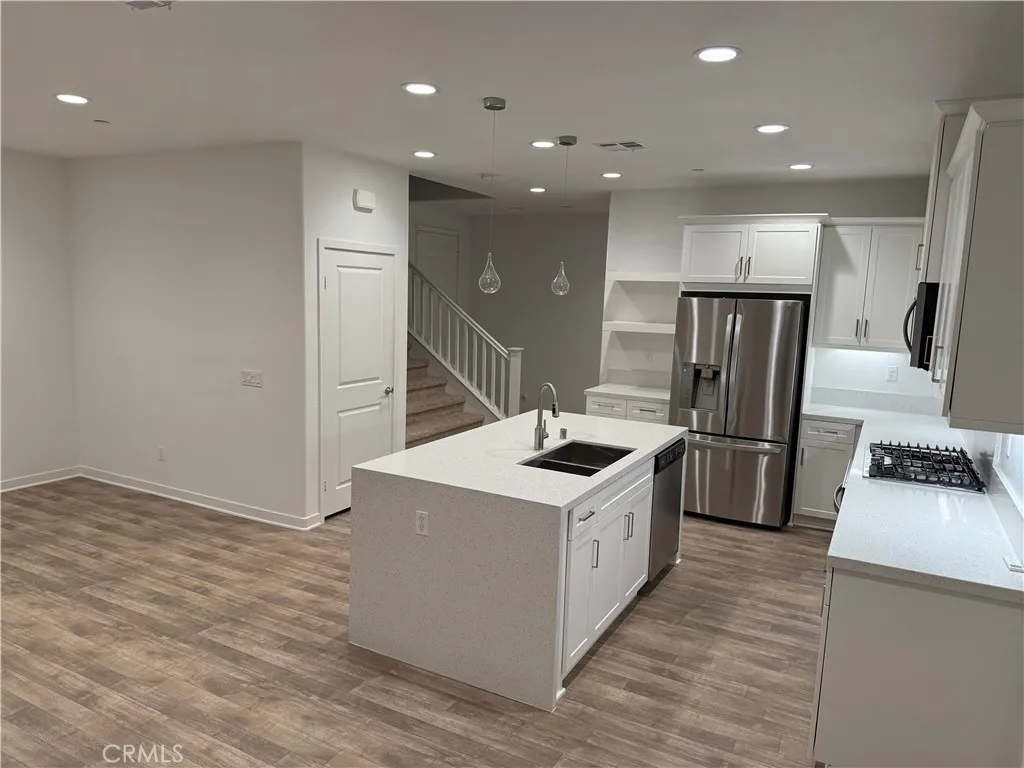 9504 North Corterra Panorama City, CA 91402 - Photo 3 of 24 a kitchen with stainless steel appliances a sink a stove a refrigerator and cabinets
