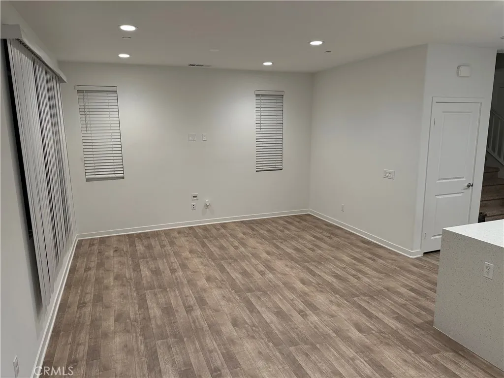 9504 North Corterra Panorama City, CA 91402 - Photo 4 of 24 an empty room with wooden floor and window