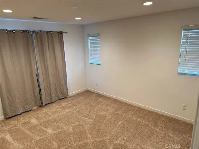 an empty room with a empty space and windows