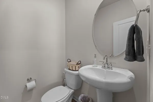 a bathroom with a sink a toilet and mirror