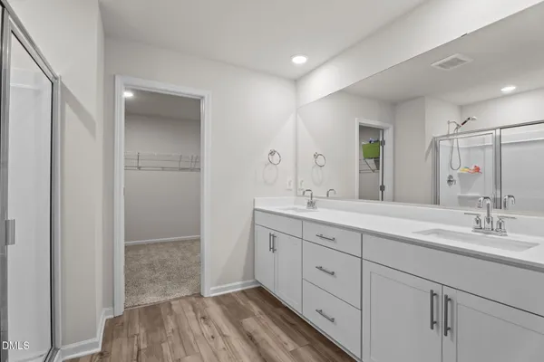 a spacious bathroom with a double vanity sink and mirror