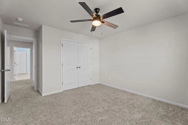 an empty room with ceiling fan