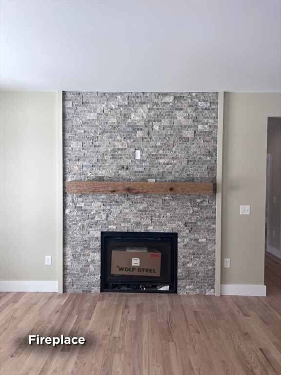 337 Chicopee Street, Unit LOT 8 Granby, MA 01033 - Photo 17 of 21 a view of empty room with wooden floor and fireplace