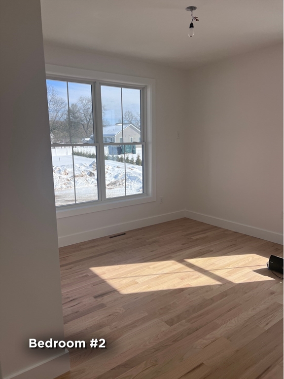 337 Chicopee Street, Unit LOT 8 Granby, MA 01033 - Photo 10 of 21 a view of empty room with wooden floor and fan