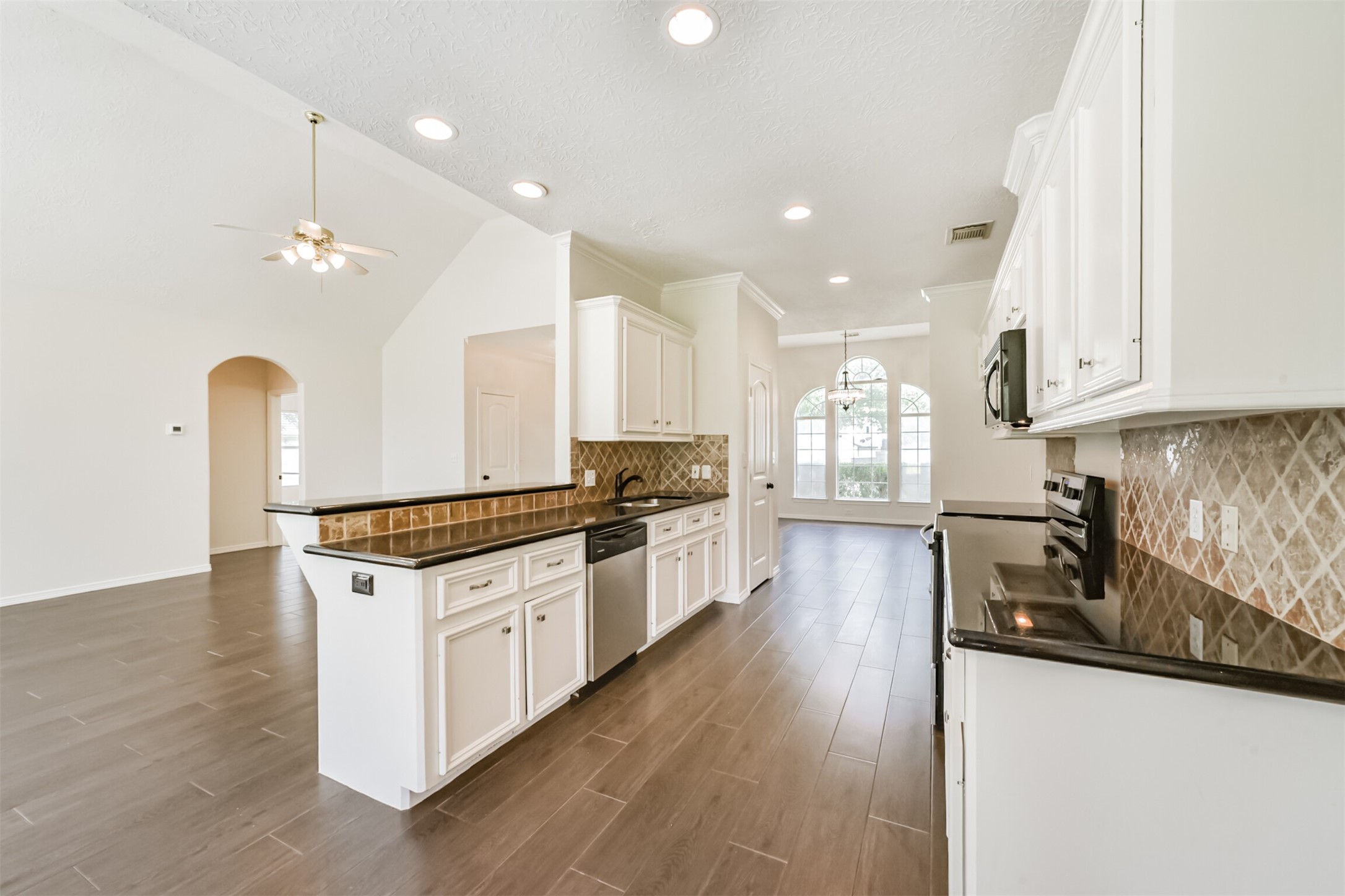 27322 Afton Way Huffman, TX 77336 - Photo 16 of 50 Well-appointed kitchen offers granite countertops, extensive cabinetry, breakfast bar seating, and stainless steel appliances.
