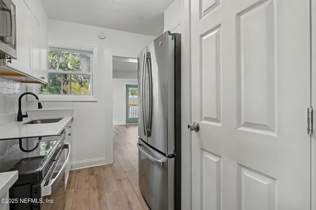 an empty room with windows and closet