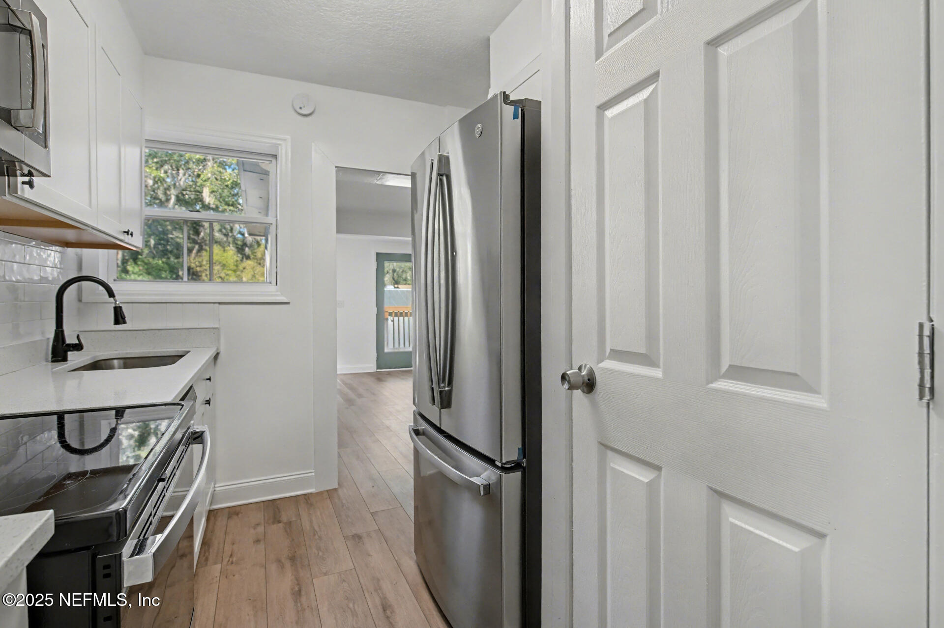 1503 Broome Street Fernandina Beach, FL 32034 - Photo 13 of 38 a bathroom with a sink a mirror a vanity and a shower