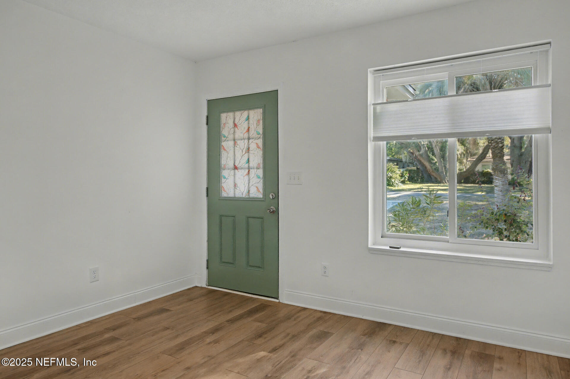 1503 Broome Street Fernandina Beach, FL 32034 - Photo 17 of 38 an empty room with wooden floor and a window