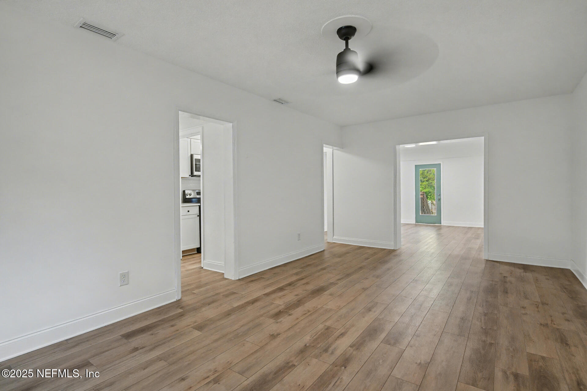 1503 Broome Street Fernandina Beach, FL 32034 - Photo 19 of 38 wooden floor in an empty room with a window