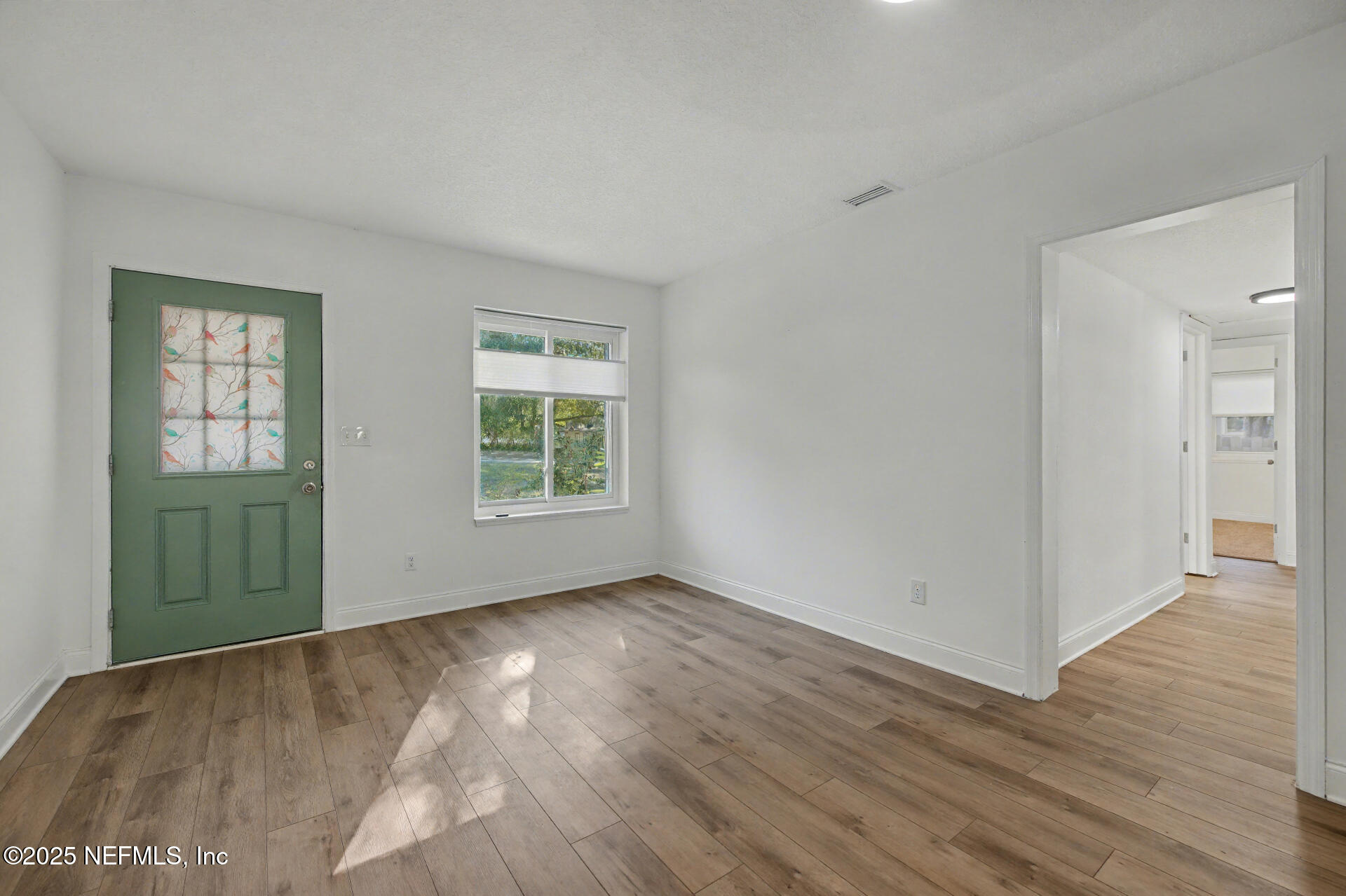1503 Broome Street Fernandina Beach, FL 32034 - Photo 28 of 38 an empty room with wooden floor and windows