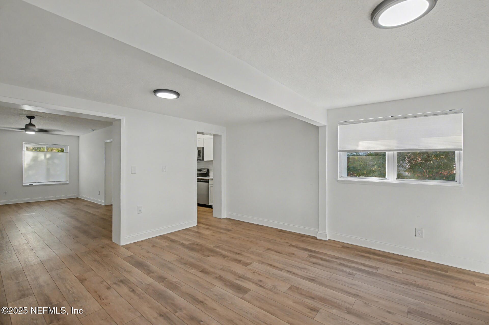 1503 Broome Street Fernandina Beach, FL 32034 - Photo 4 of 38 a view of an empty room with wooden floor and a window