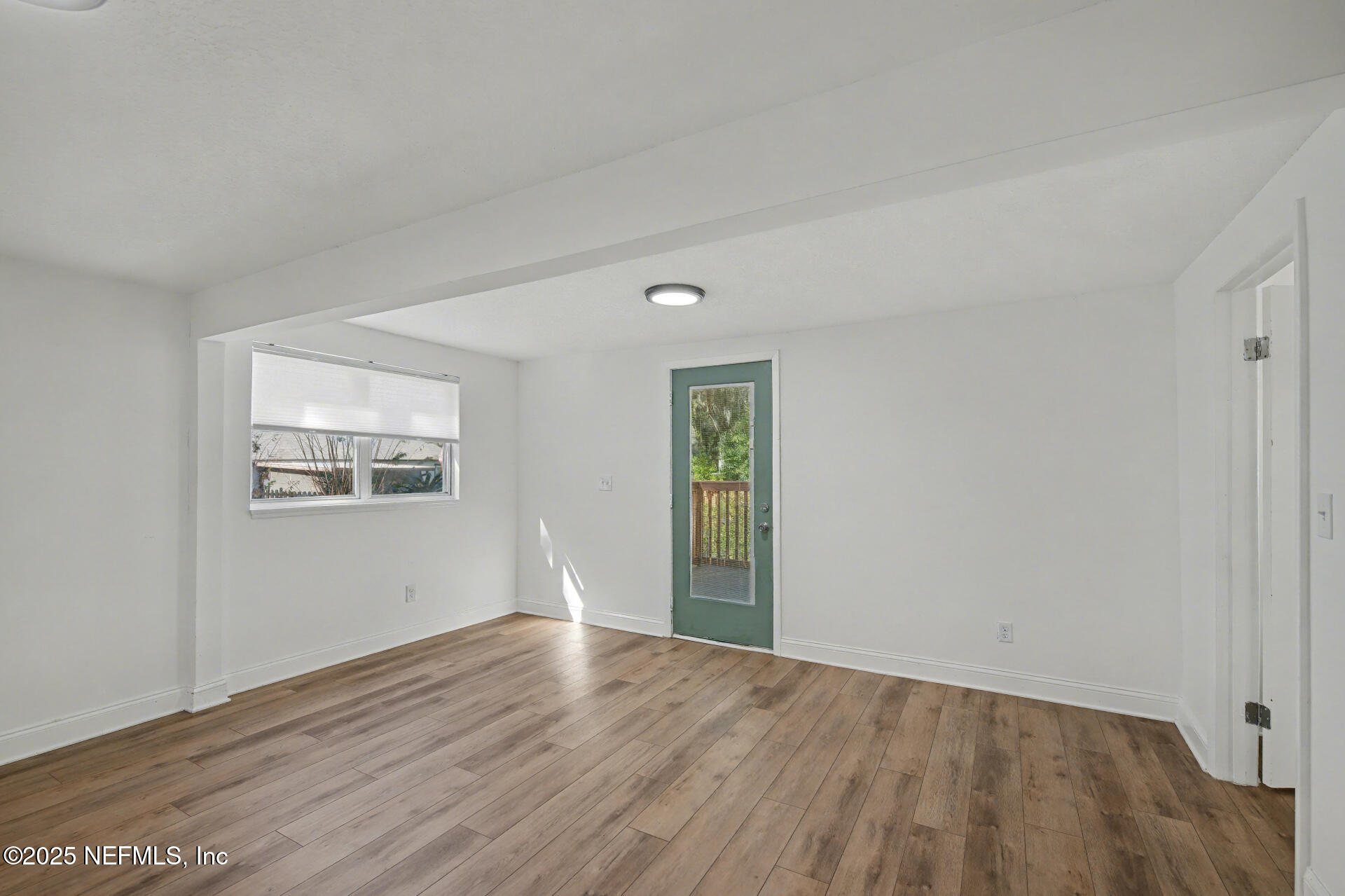 1503 Broome Street Fernandina Beach, FL 32034 - Photo 6 of 38 a view of an empty room with wooden floor and a window